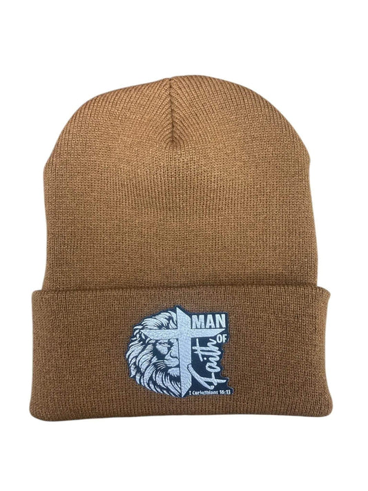 A tan leather patch beanie engraved with "Man of Faith" and "1 Corinthians 16:13" wording overlaid with a lion and cross, all set on a white background.
