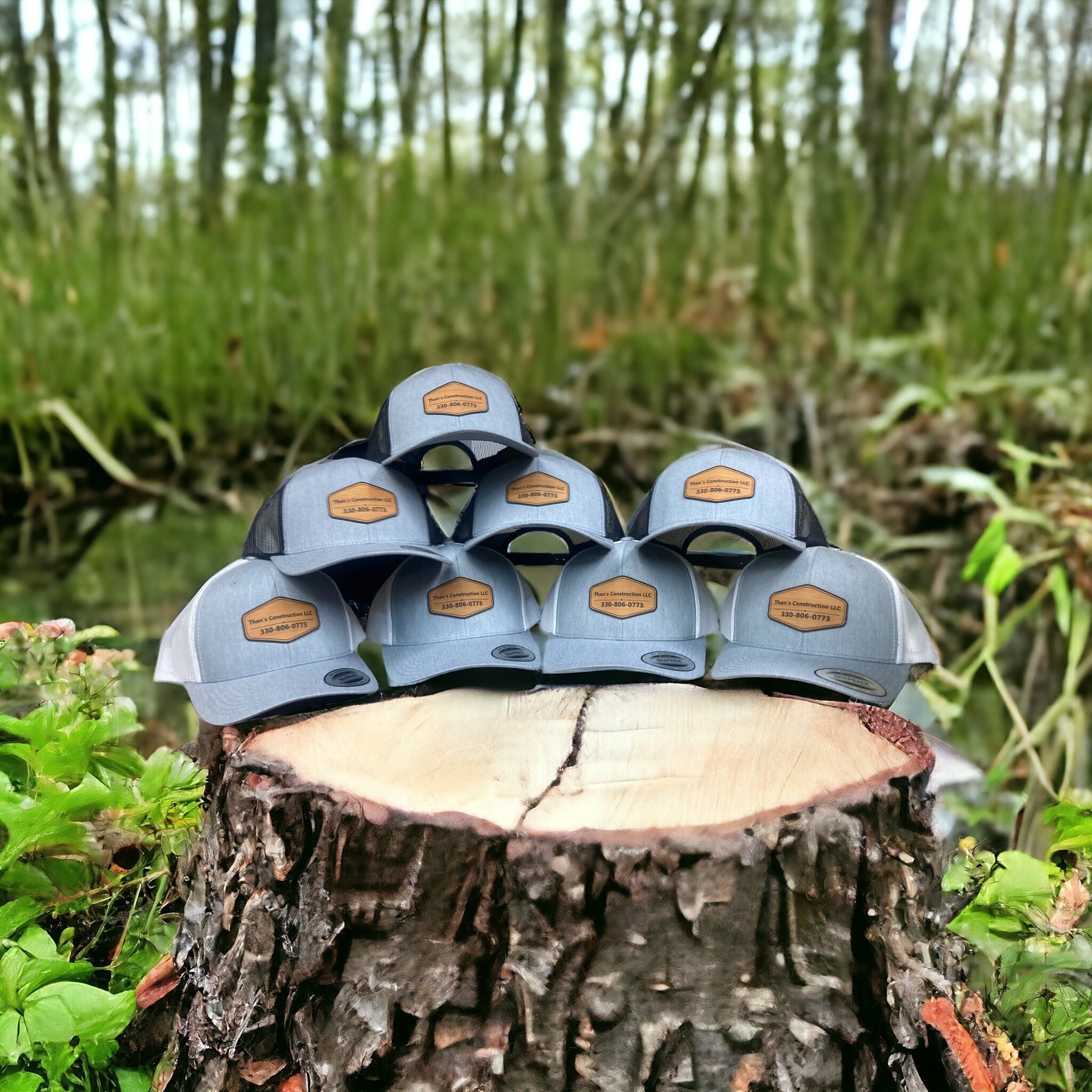 Completed group of custom leatherette patch trucker hats in multiple colors.